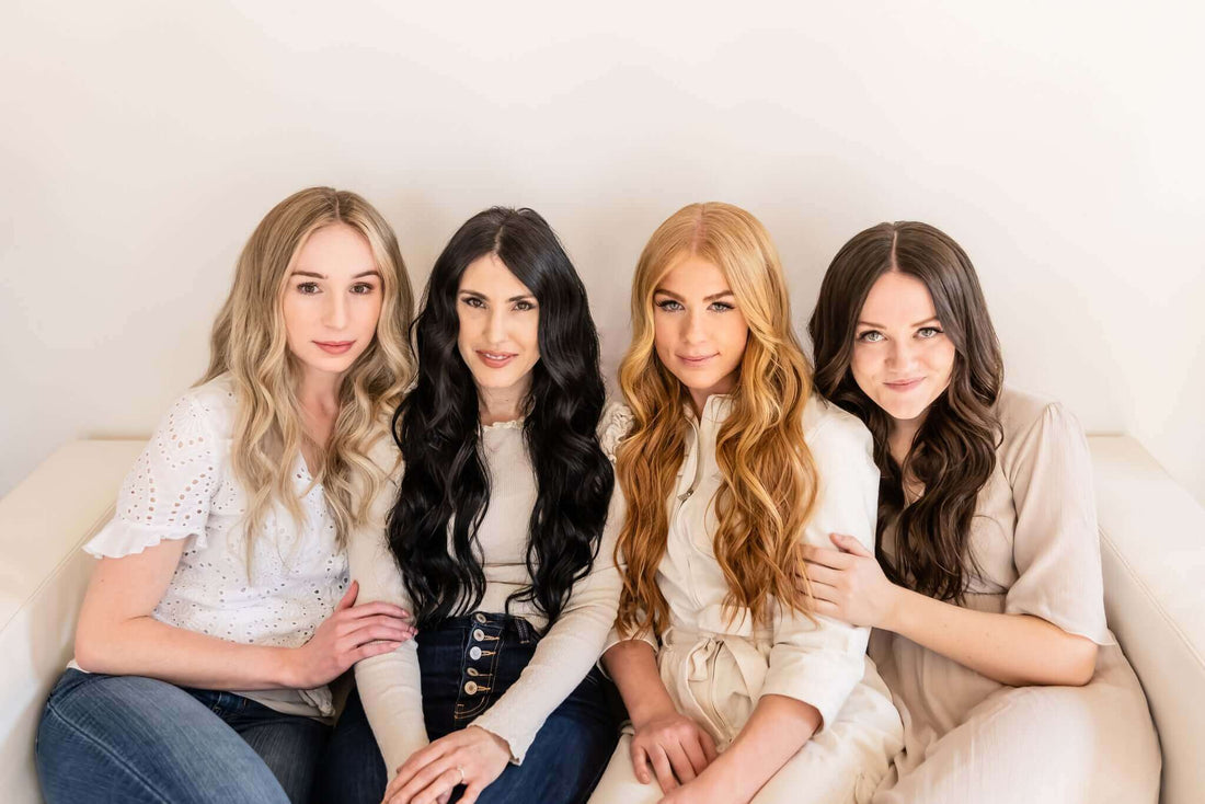 Four women with different hairstyles sitting together on a couch, showcasing beauty and self-care.